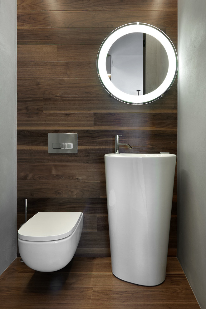 Large contemporary powder room in Los Angeles with a wall-mount toilet, brown walls, an integrated sink and brown floor.