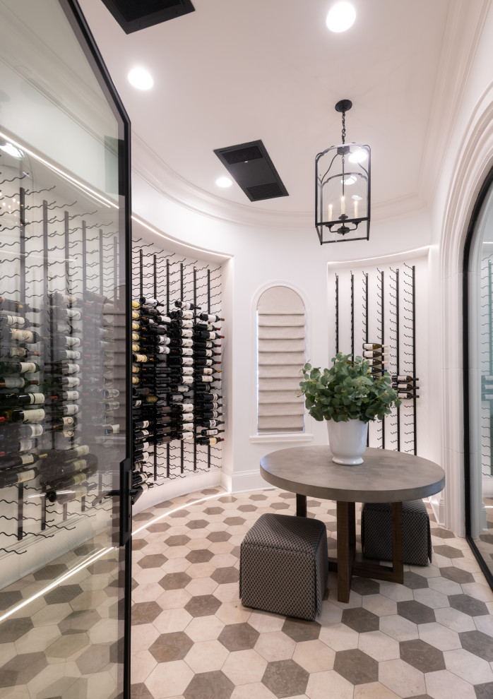 Photo of a large traditional wine cellar in Dallas with limestone floors, storage racks and white floor.