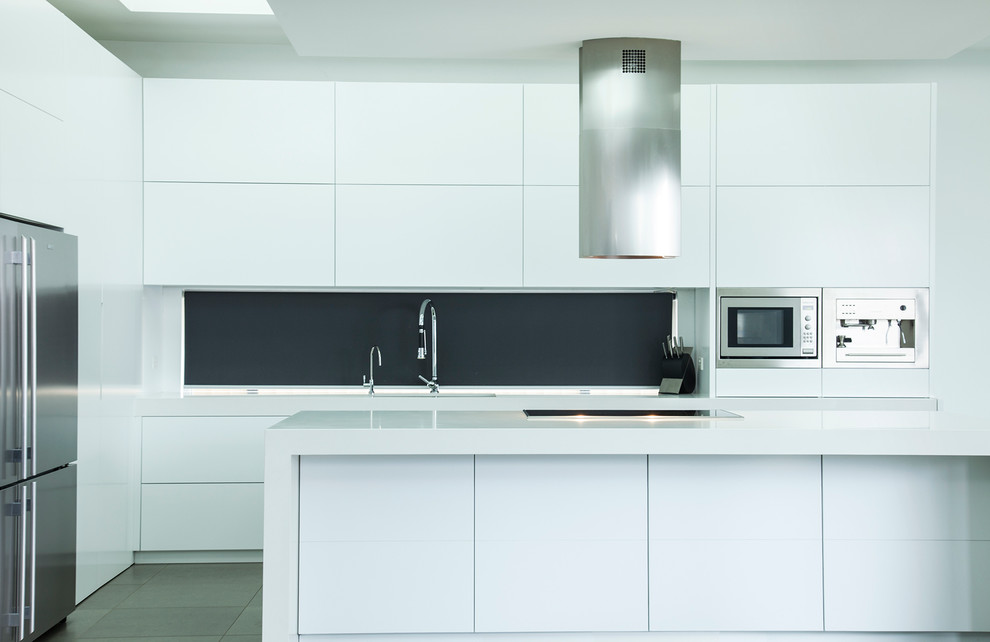 Large modern l-shaped eat-in kitchen in Sydney with an undermount sink, flat-panel cabinets, white cabinets, quartz benchtops, stainless steel appliances, porcelain floors and with island.