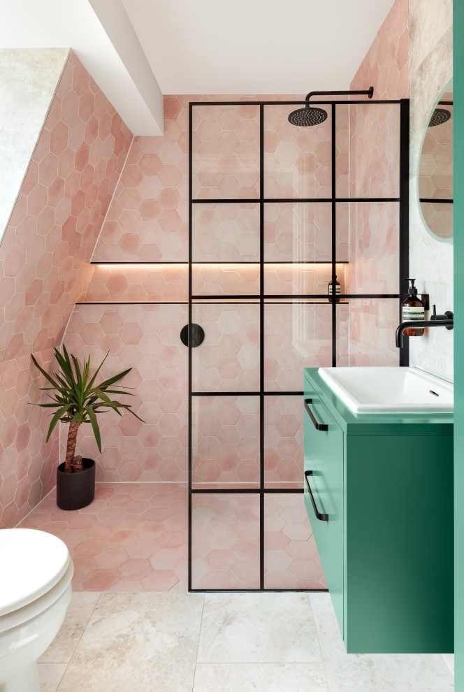 Small contemporary ensuite bathroom in London with flat-panel cabinets, green cabinets, a one-piece toilet, pink tiles, ceramic tiles, ceramic flooring, an integrated sink, grey floors, an open shower, green worktops, a single sink, a floating vanity unit and an alcove shower.