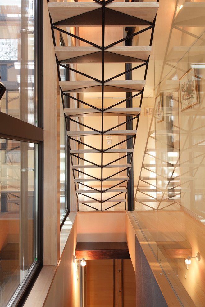 This is an example of a contemporary wood straight staircase in Other with open risers.