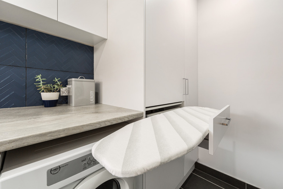 Small contemporary galley laundry cupboard in Melbourne with a drop-in sink, raised-panel cabinets, white cabinets, wood benchtops, white walls, ceramic floors, a side-by-side washer and dryer, grey floor and grey benchtop.