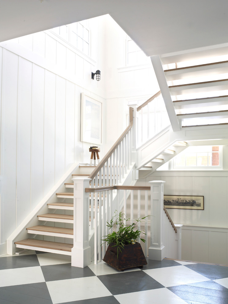 Beach style wood u-shaped staircase in San Diego with open risers.