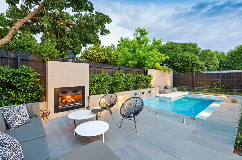 Photo of a mid-sized contemporary backyard patio in Melbourne with with fireplace and no cover.