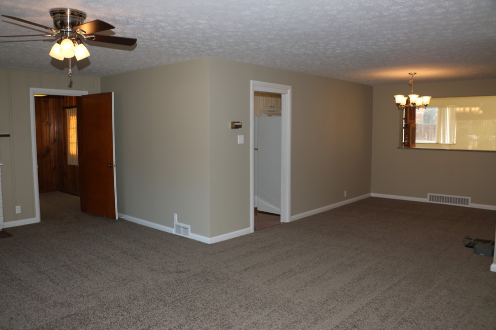 Mid-sized elegant open concept carpeted home design photo with gray walls, a standard fireplace and a brick fireplace