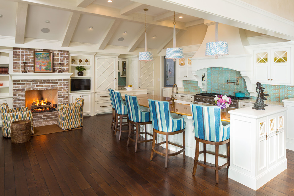 Inspiration for a beach style open plan kitchen in Minneapolis with recessed-panel cabinets, white cabinets, green splashback, stainless steel appliances, dark hardwood floors and with island.