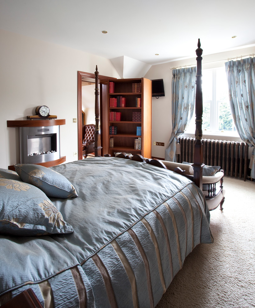 Traditional master bedroom in Dublin with beige walls, carpet, a standard fireplace and a metal fireplace surround.