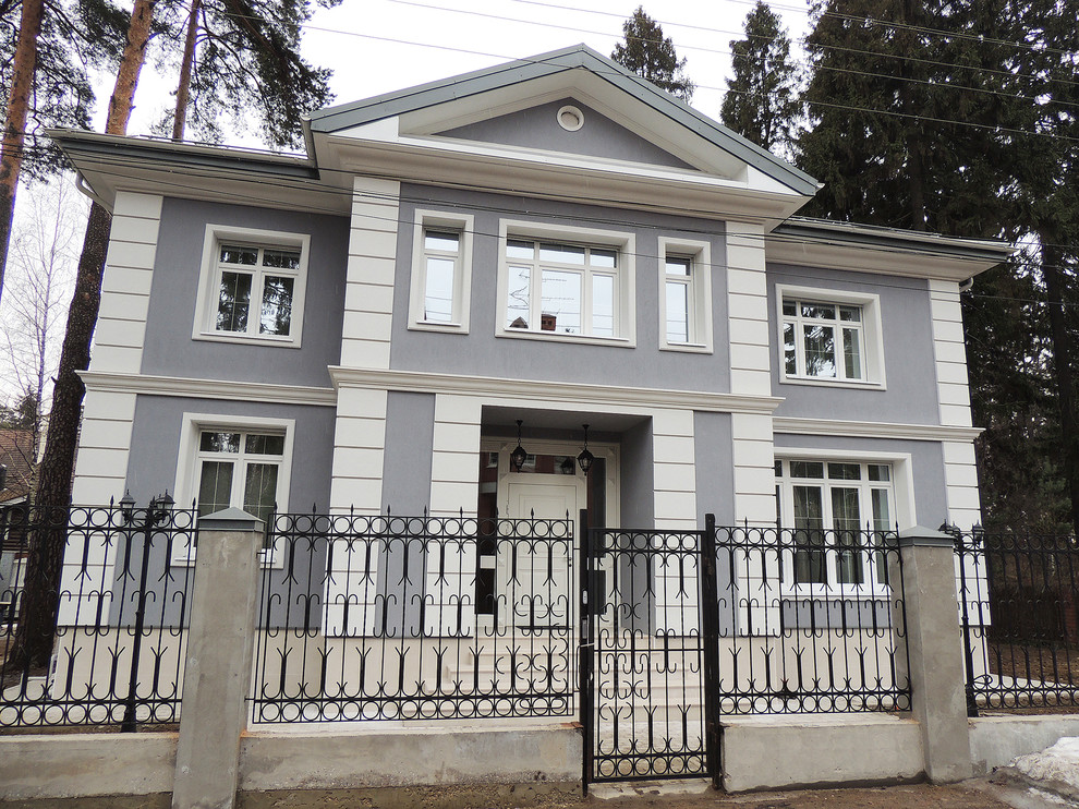 Design ideas for a traditional two-storey grey exterior in Moscow with a gable roof.
