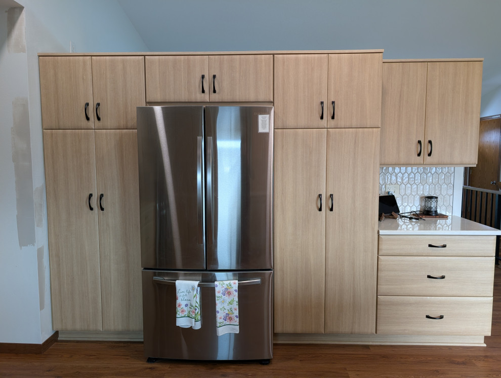 Inspiration for a mid-sized transitional u-shaped eat-in kitchen remodel with flat-panel cabinets, light wood cabinets and quartz countertops