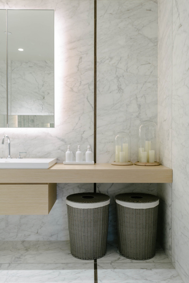 Mid-sized contemporary master bathroom in New York with flat-panel cabinets, light wood cabinets, white tile, stone slab, wood benchtops, a double vanity and a floating vanity.