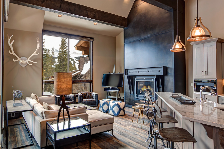 Example of a transitional formal and open concept medium tone wood floor living room design in Denver with gray walls and a standard fireplace