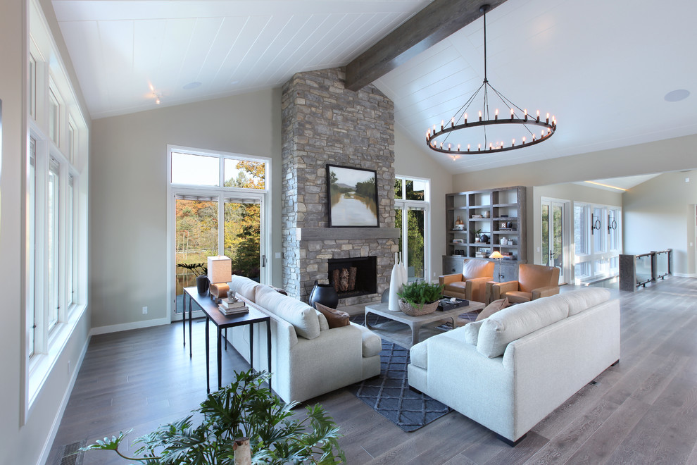 Design ideas for a large transitional open concept family room in Grand Rapids with beige walls, medium hardwood floors, a two-sided fireplace and a stone fireplace surround.