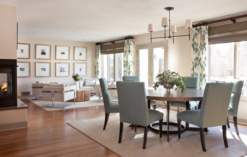 Inspiration for a mid-sized transitional open plan dining in Denver with beige walls, medium hardwood floors, a corner fireplace, a metal fireplace surround and brown floor.