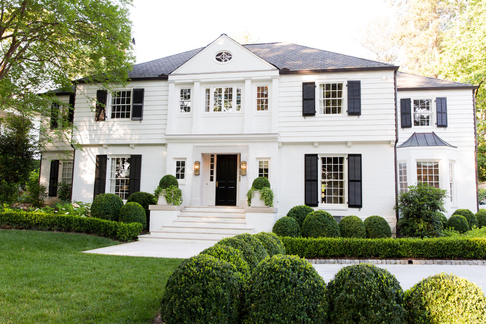 Design ideas for a traditional two-storey white house exterior in Atlanta with a hip roof.