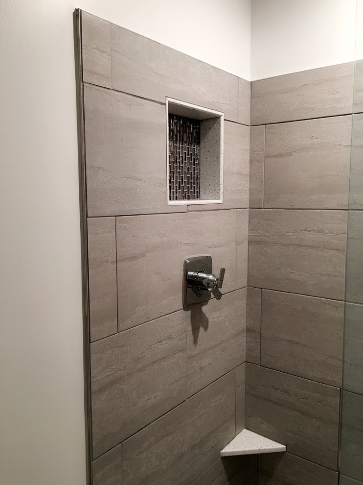 Alcove shower - mid-sized transitional beige tile, brown tile and porcelain tile porcelain tile and beige floor alcove shower idea in Detroit with a two-piece toilet and beige walls
