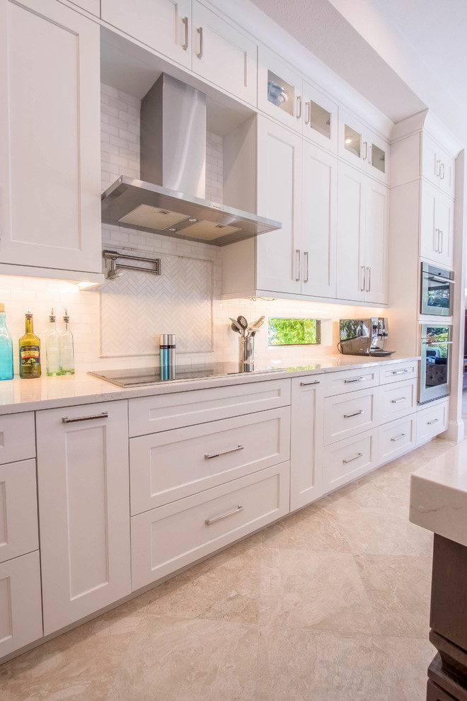 Inspiration for a huge transitional l-shaped porcelain tile and beige floor open concept kitchen remodel with a farmhouse sink, shaker cabinets, white cabinets, quartz countertops, white backsplash, porcelain backsplash, stainless steel appliances and two islands