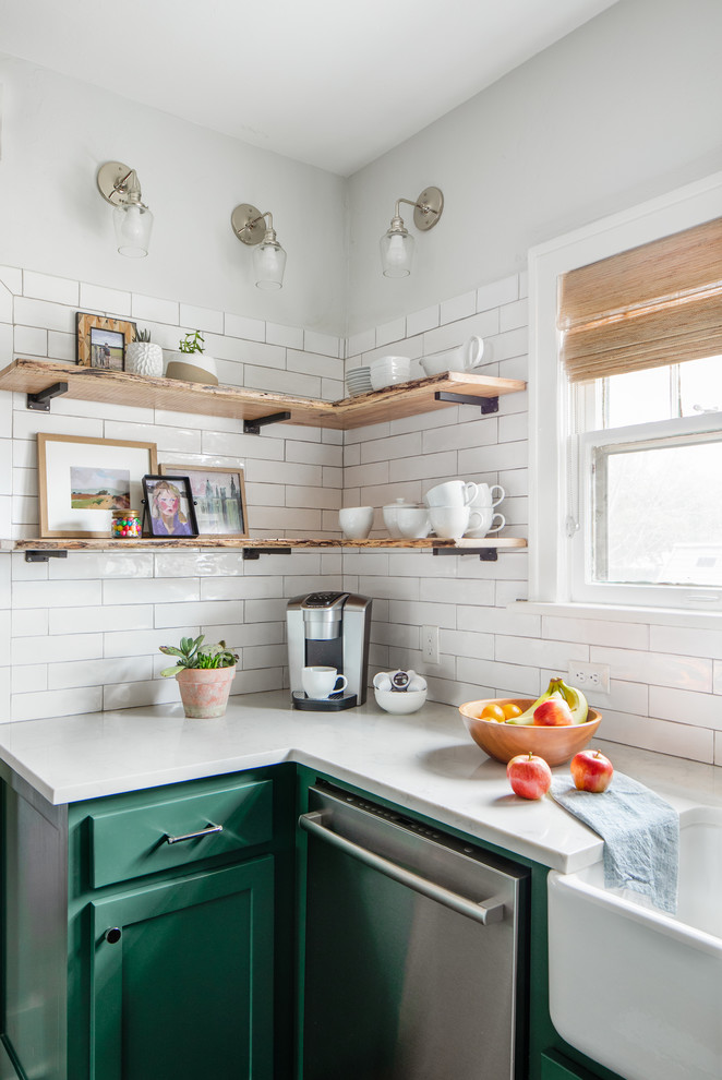 Mid-sized transitional medium tone wood floor and brown floor kitchen photo in Chicago with a farmhouse sink, shaker cabinets, green cabinets, quartz countertops, white backsplash, subway tile backsplash, stainless steel appliances, an island and white countertops