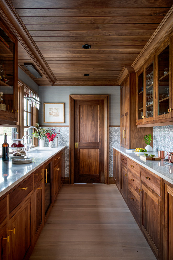 Arts and crafts kitchen pantry in Boston with shaker cabinets, white cabinets and with island.