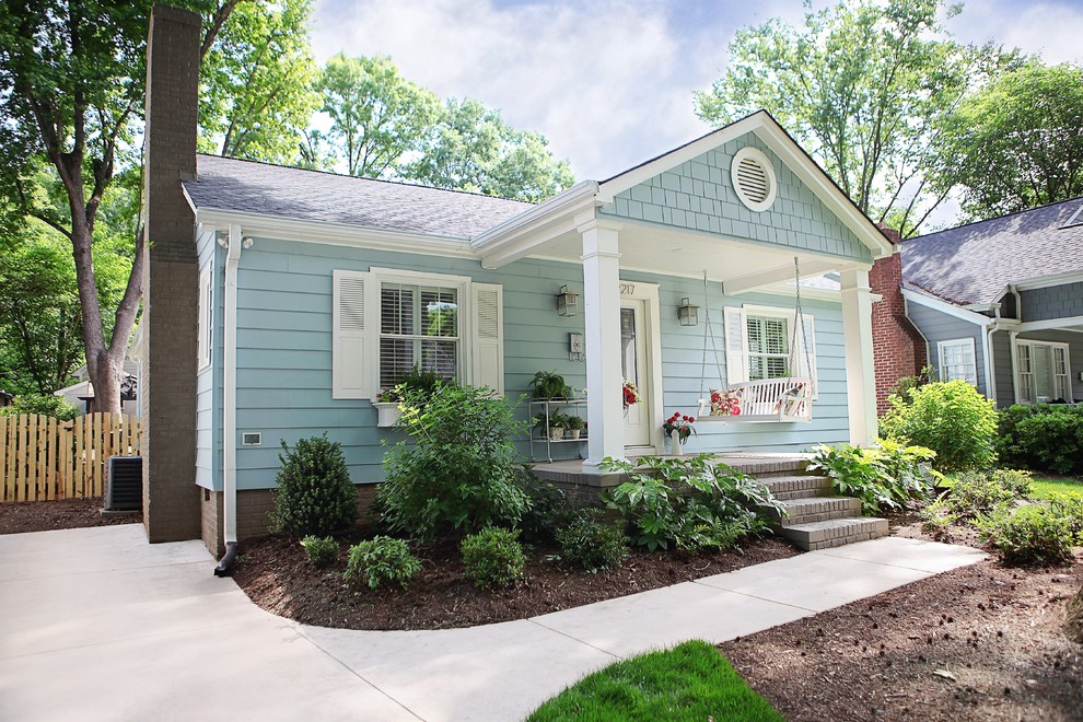 Photo of a mid-sized arts and crafts one-storey blue exterior in Charlotte with metal siding.