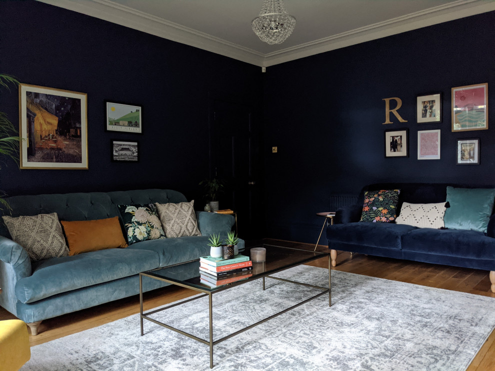 Photo of a mid-sized eclectic living room in Other with blue walls and light hardwood floors.
