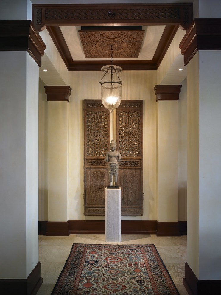 Photo of a mid-sized asian entry hall in Wichita with beige walls and marble floors.