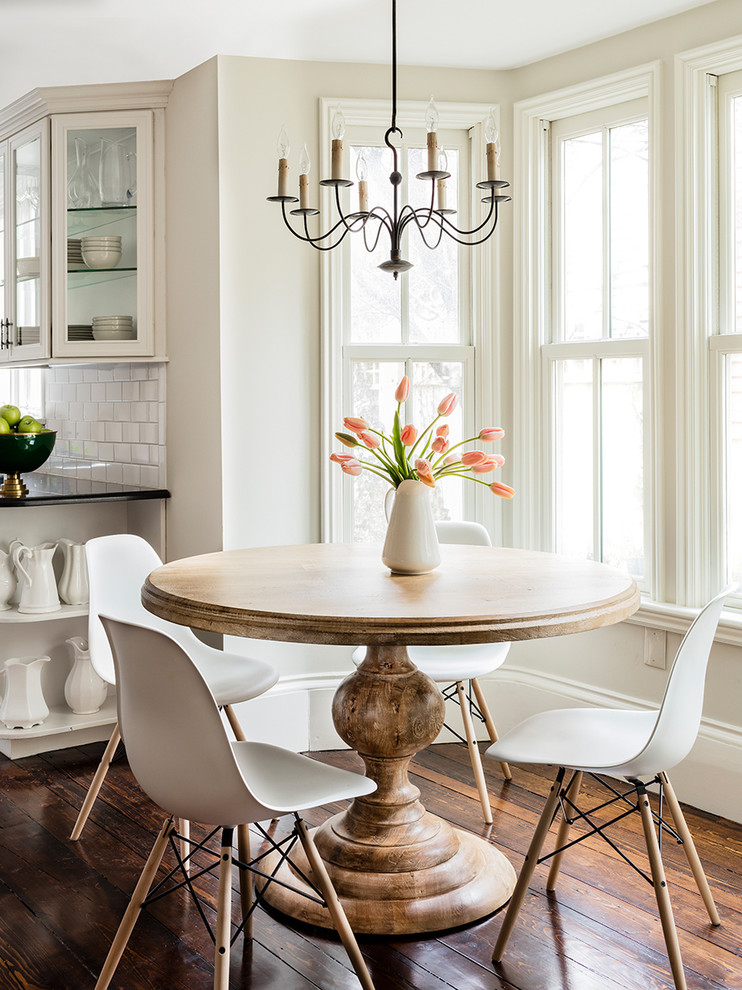 Beach style dining room in Boston with white walls and dark hardwood floors.