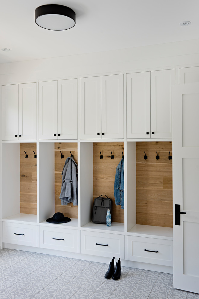 Mudroom - transitional multicolored floor and wood wall mudroom idea in Toronto with white walls