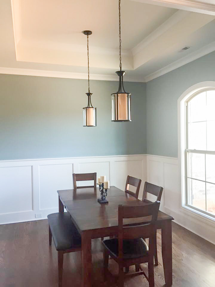 This is an example of a mid-sized traditional dining room in Raleigh with multi-coloured walls, medium hardwood floors and brown floor.