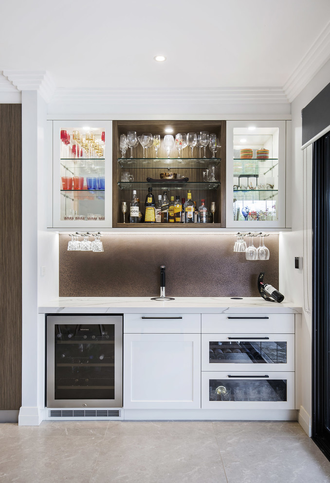 Photo of a small modern single-wall wet bar in Sydney with shaker cabinets, white cabinets, quartz benchtops, limestone floors, beige floor, no sink, brown splashback and metal splashback.
