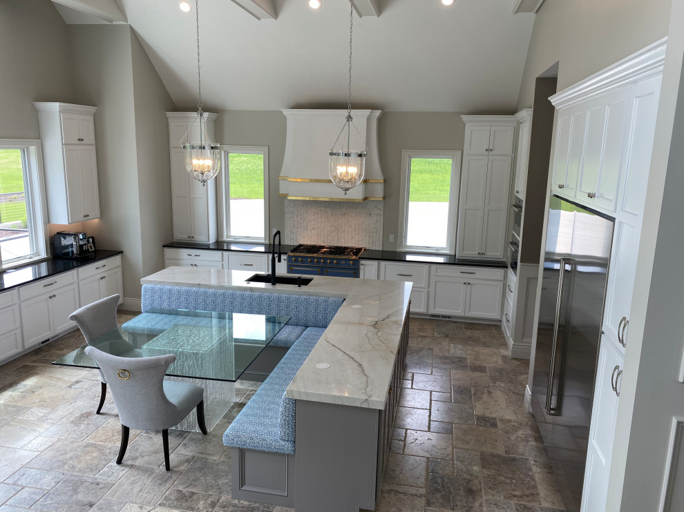 Photo of an expansive u-shaped eat-in kitchen in Cedar Rapids with beaded inset cabinets, white cabinets, marble benchtops, white splashback, porcelain splashback, with island, beige floor, white benchtop and vaulted.