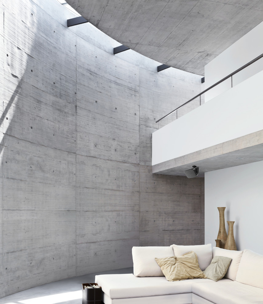 Design ideas for a large contemporary open concept home theatre in New York with grey walls and concrete floors.