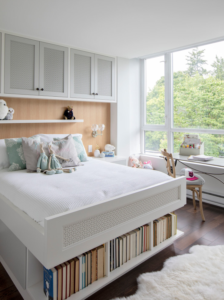 Design ideas for a contemporary kids' bedroom for girls in Vancouver with white walls, dark hardwood floors and brown floor.