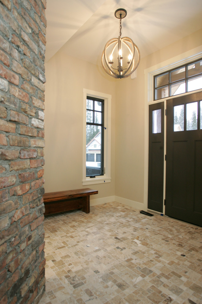 Entryway - transitional travertine floor entryway idea in Calgary with a black front door