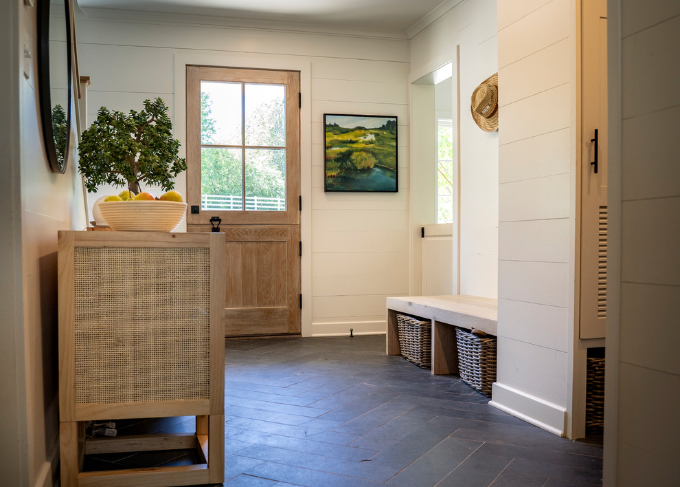 Mid-sized country mudroom in Other with white walls, slate floors, a dutch front door, a light wood front door and black floor.