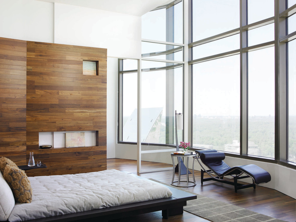 This is an example of a contemporary bedroom in Los Angeles with white walls and dark hardwood floors.