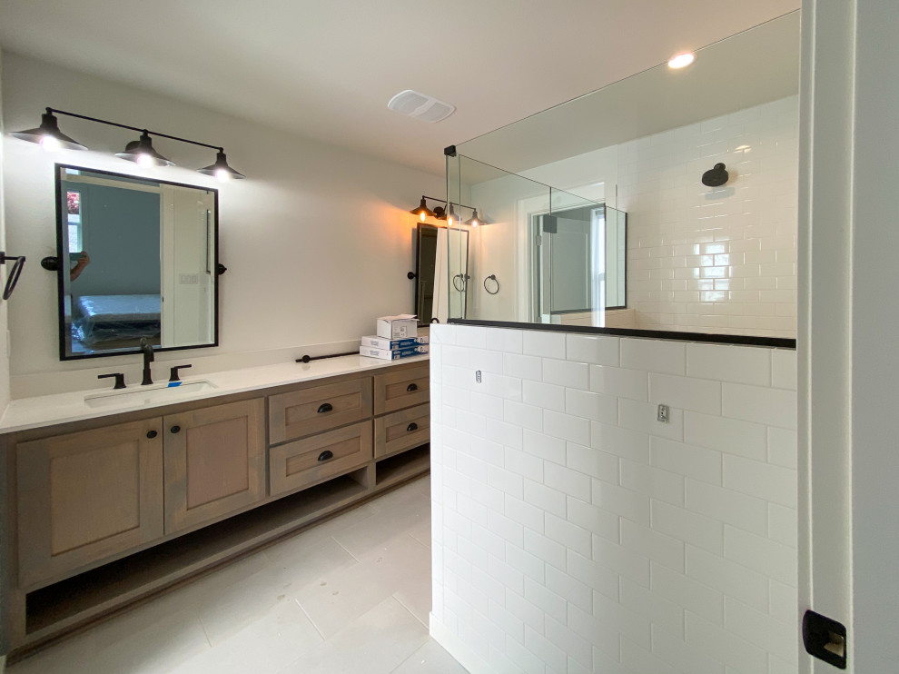 Alcove shower - mid-sized farmhouse master white tile cement tile floor, white floor and double-sink alcove shower idea in Portland with shaker cabinets, medium tone wood cabinets, a two-piece toilet, white walls, an undermount sink, quartz countertops, a hinged shower door, white countertops and a built-in vanity