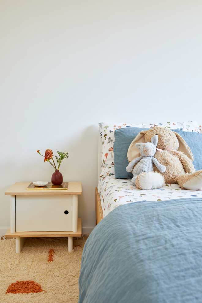 Kids' bedroom - bedroom and large modern girl light wood floor and brown floor kids' bedroom idea in San Francisco with white walls