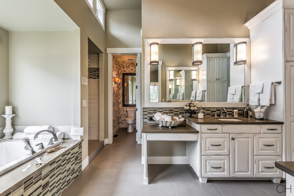 Mid-sized transitional master bathroom in Orange County with raised-panel cabinets, white cabinets, an alcove tub, an alcove shower, a one-piece toilet, beige tile, black tile, black and white tile, white tile, porcelain tile, beige walls, ceramic floors, an undermount sink, granite benchtops, beige floor and an open shower.