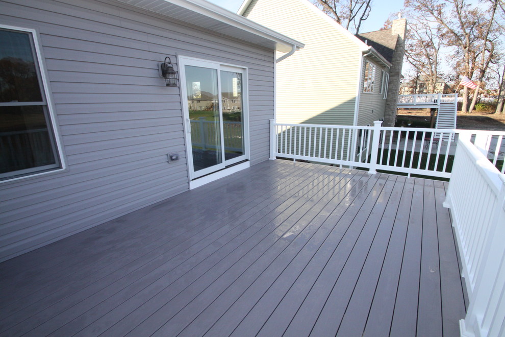 This is an example of a mid-sized arts and crafts backyard deck in Chicago with no cover.