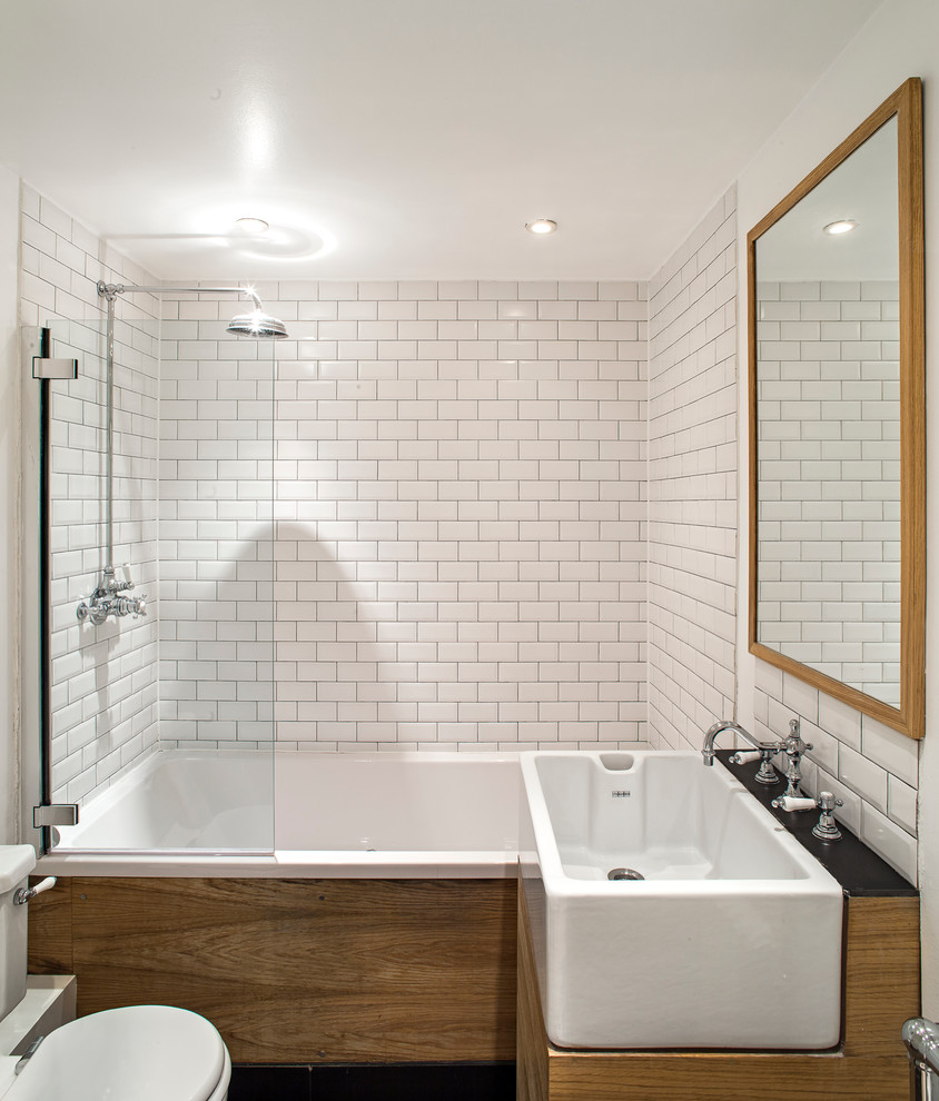 Design ideas for a contemporary bathroom in London with a shower/bathtub combo and subway tile.