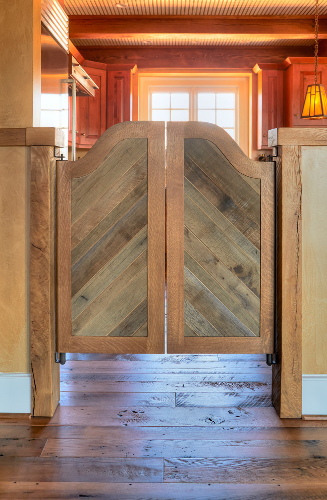 Example of a mountain style medium tone wood floor hallway design with beige walls