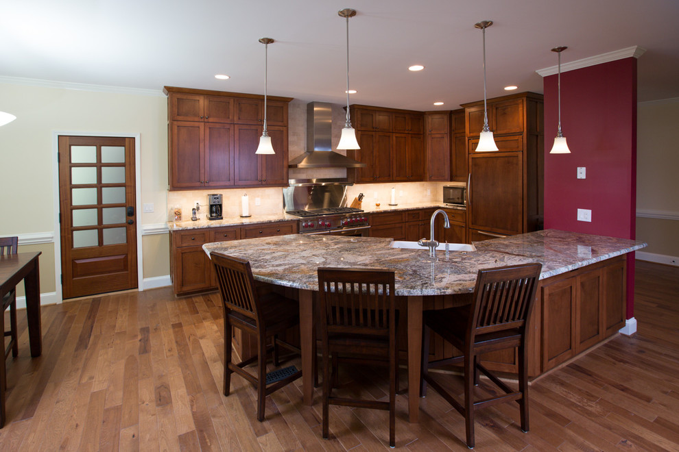 Inspiration for a large transitional l-shaped dark wood floor eat-in kitchen remodel in Charlotte with an undermount sink, raised-panel cabinets, white cabinets, granite countertops, beige backsplash, subway tile backsplash, stainless steel appliances and an island