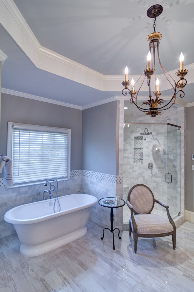 Photo of a large traditional master bathroom in Atlanta with a drop-in sink, furniture-like cabinets, medium wood cabinets, quartzite benchtops, a freestanding tub, a corner shower, gray tile, stone tile, grey walls, porcelain floors, grey floor and a hinged shower door.