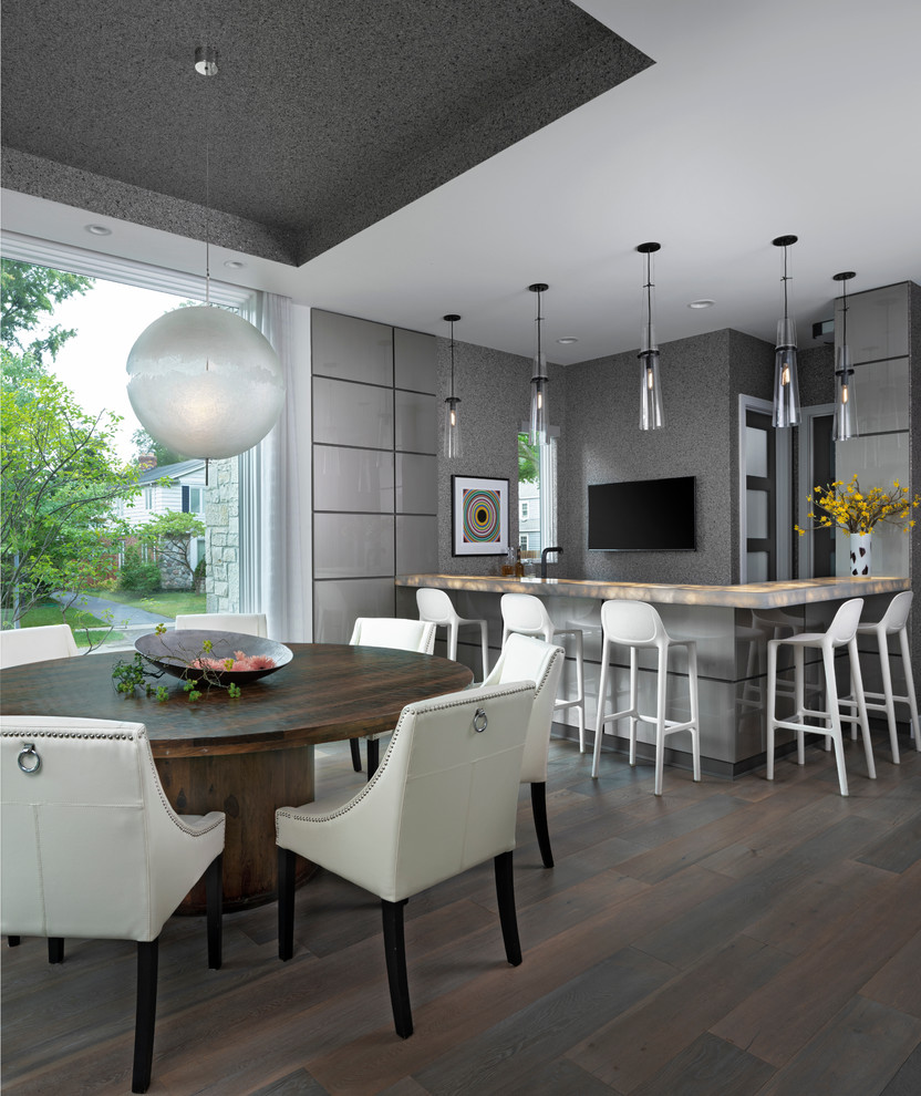 This is an example of a large contemporary dining room in Detroit with grey walls and medium hardwood floors.