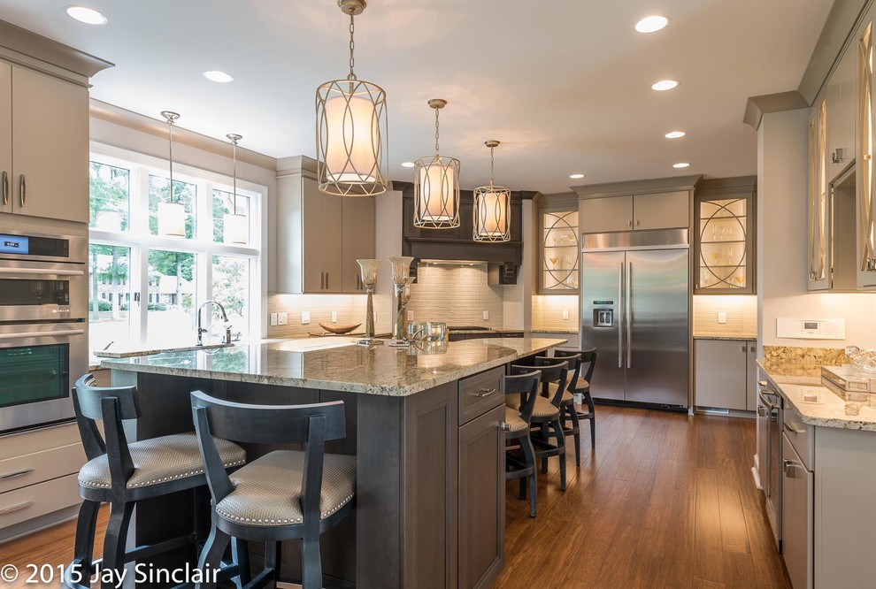 Huge transitional u-shaped medium tone wood floor eat-in kitchen photo with an undermount sink, recessed-panel cabinets, dark wood cabinets, stainless steel appliances, granite countertops, beige backsplash, porcelain backsplash and an island
