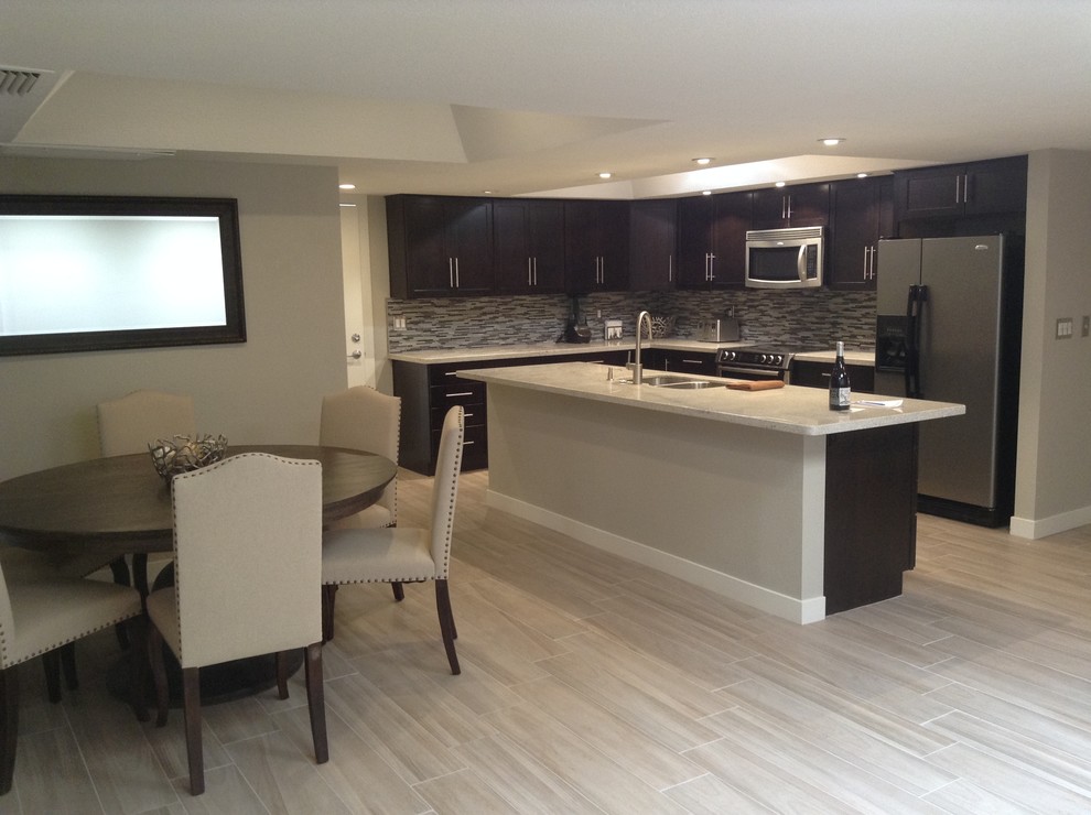 Inspiration for a mid-sized transitional u-shaped dark wood floor eat-in kitchen remodel in Phoenix with a double-bowl sink, raised-panel cabinets, dark wood cabinets, wood countertops, white backsplash, subway tile backsplash, white appliances and no island