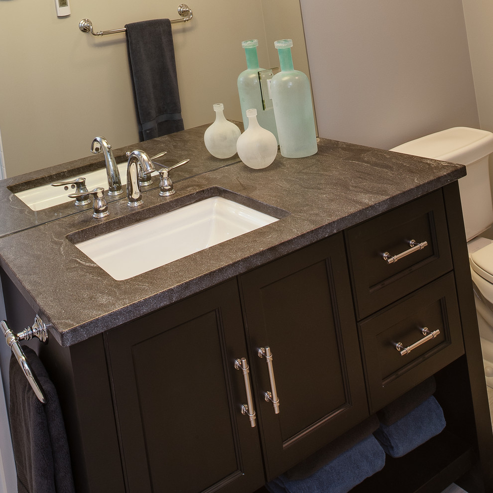 Design ideas for a small transitional 3/4 bathroom in Other with an undermount sink, recessed-panel cabinets, black cabinets, granite benchtops, an alcove shower, a one-piece toilet, multi-coloured tile, ceramic tile, grey walls and travertine floors.