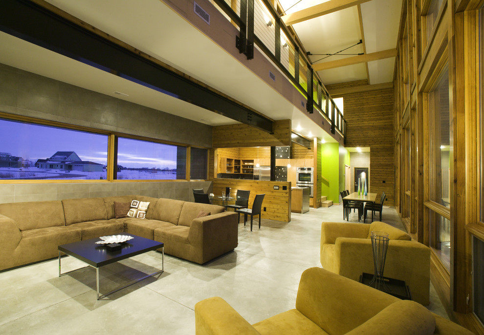 Inspiration for a modern open concept living room in Omaha with concrete floors.