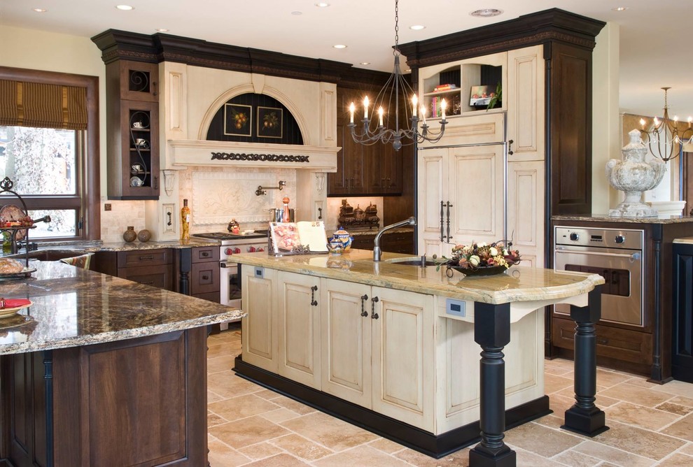 Design ideas for a mid-sized traditional u-shaped separate kitchen in Oklahoma City with an undermount sink, raised-panel cabinets, distressed cabinets, granite benchtops, beige splashback, panelled appliances, travertine floors, with island and beige floor.