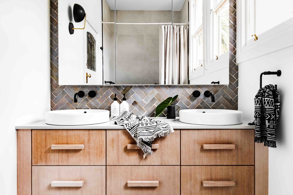 Design ideas for an eclectic bathroom in Melbourne with flat-panel cabinets, light wood cabinets, gray tile, white walls, a vessel sink and white benchtops.